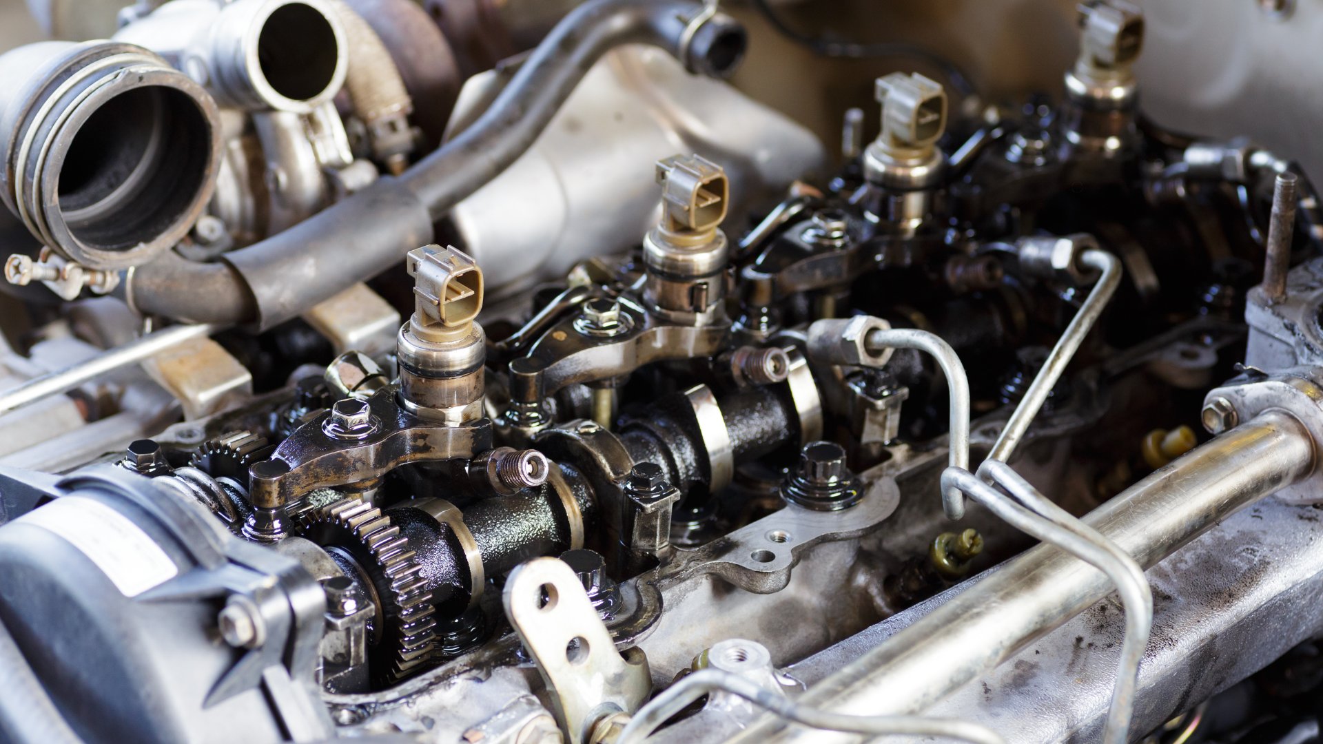 A bottle of oil is being poured into a car engine.