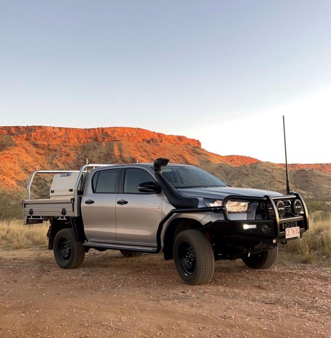 A silver ute parked in front of a red hill — Alice Springs Electrical Services In Araluen, NT