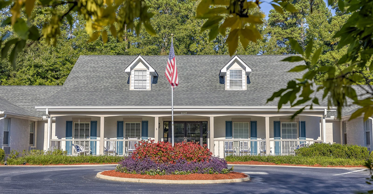 A large white house with a flag in front of it.