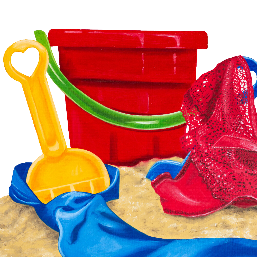 A red bucket with a green handle sits next to a yellow shovel and a blue towel