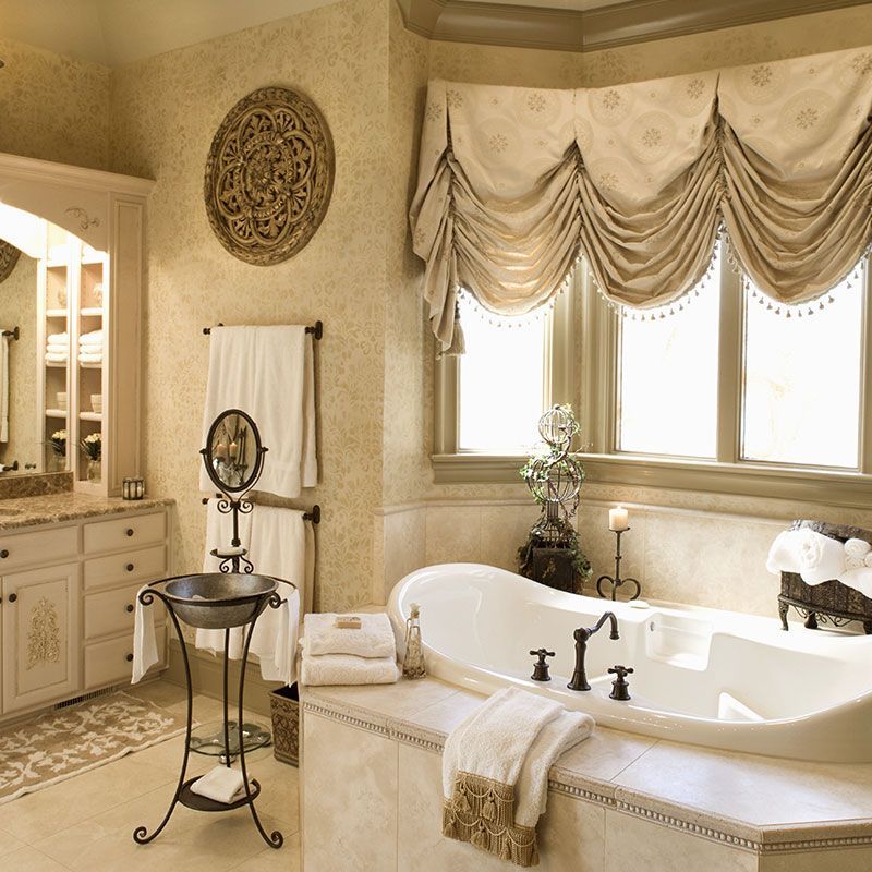 A bathroom with a tub a sink and a mirror
