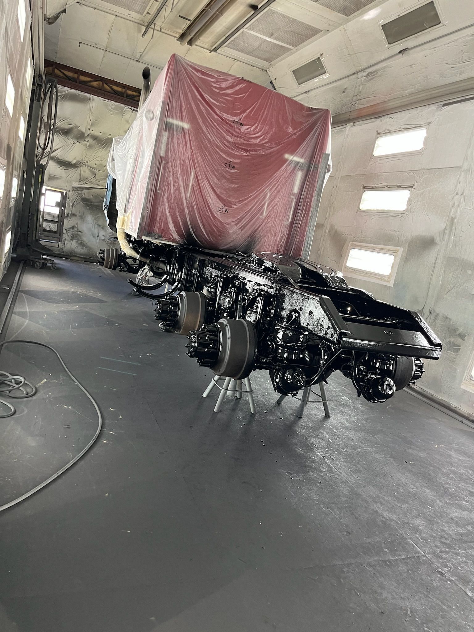 Trailer with a covered red cargo in an industrial building.