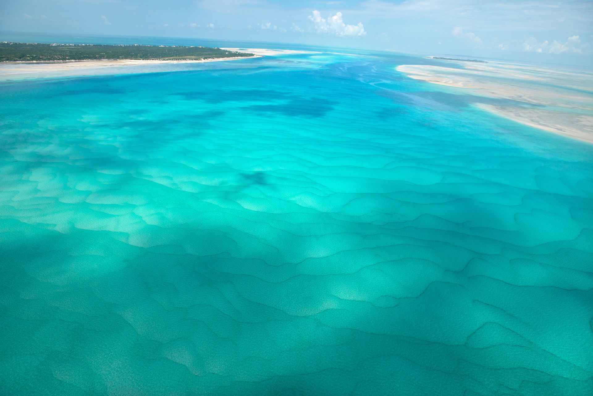 An aerial view of a tropical island in the middle of the ocean.