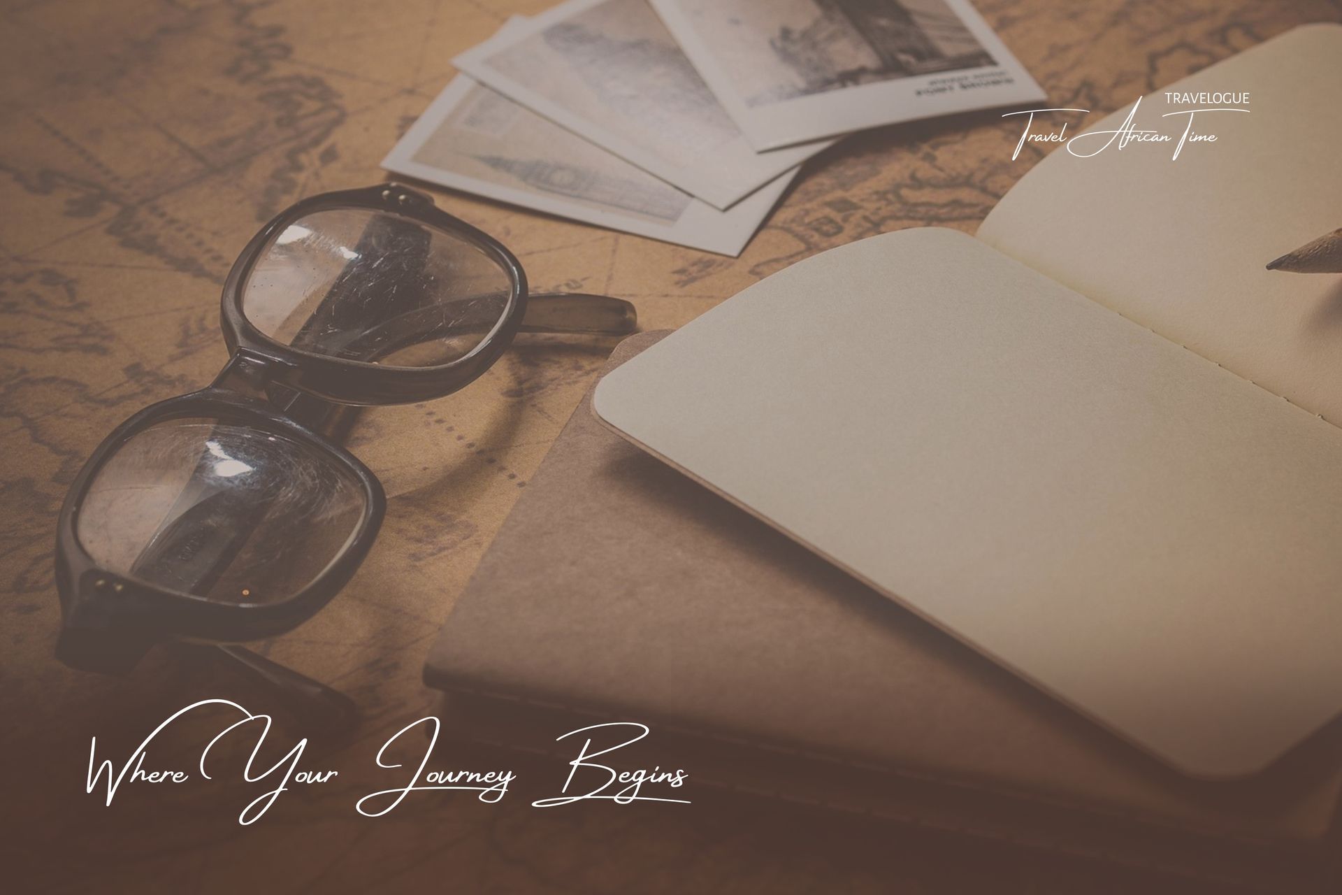 Glasses, photographs, and an open notebook resting on a vintage map, with the script 