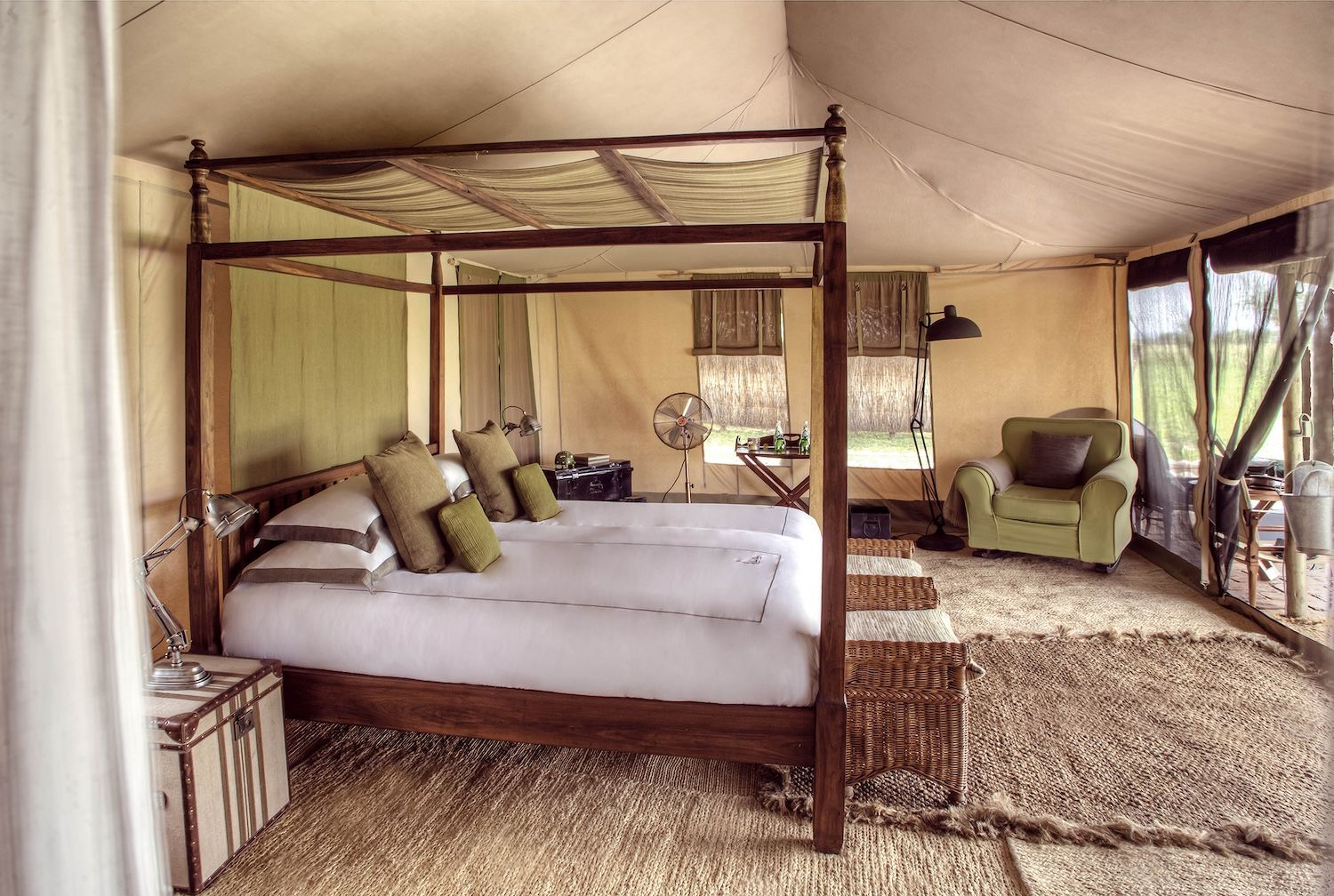 There is a four poster bed in the middle of the room.