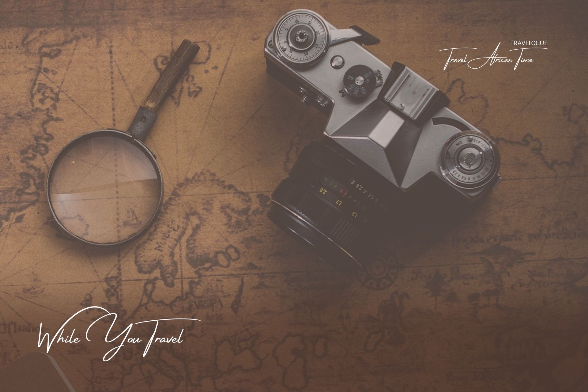 A vintage film camera and a magnifying glass rest on an old, sepia-toned world map.