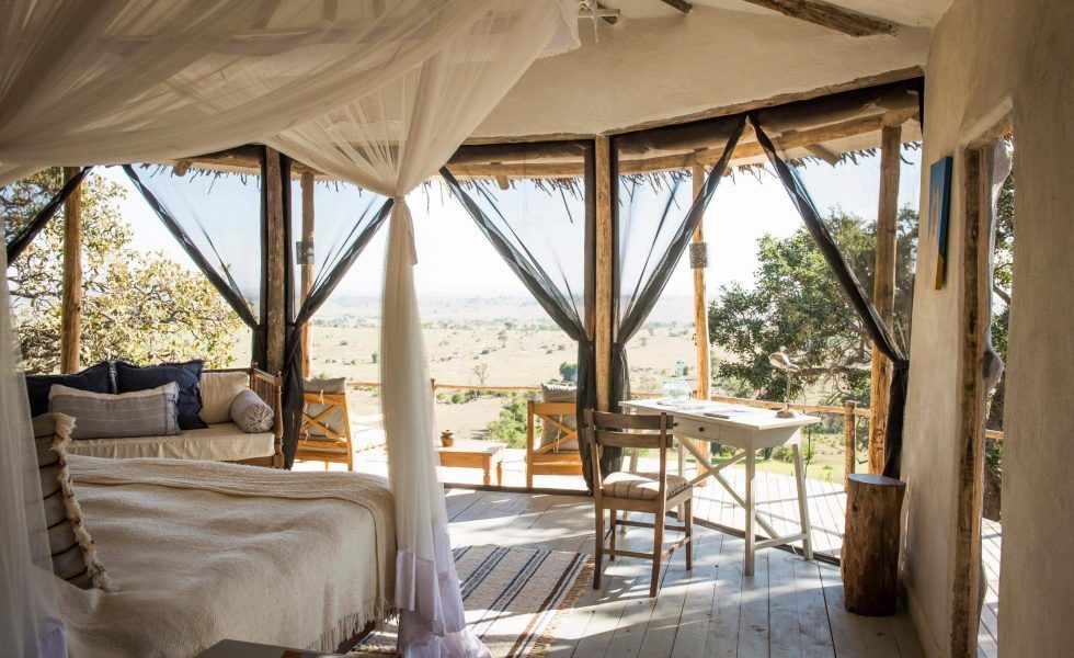 There is a canopy bed in the middle of the room.