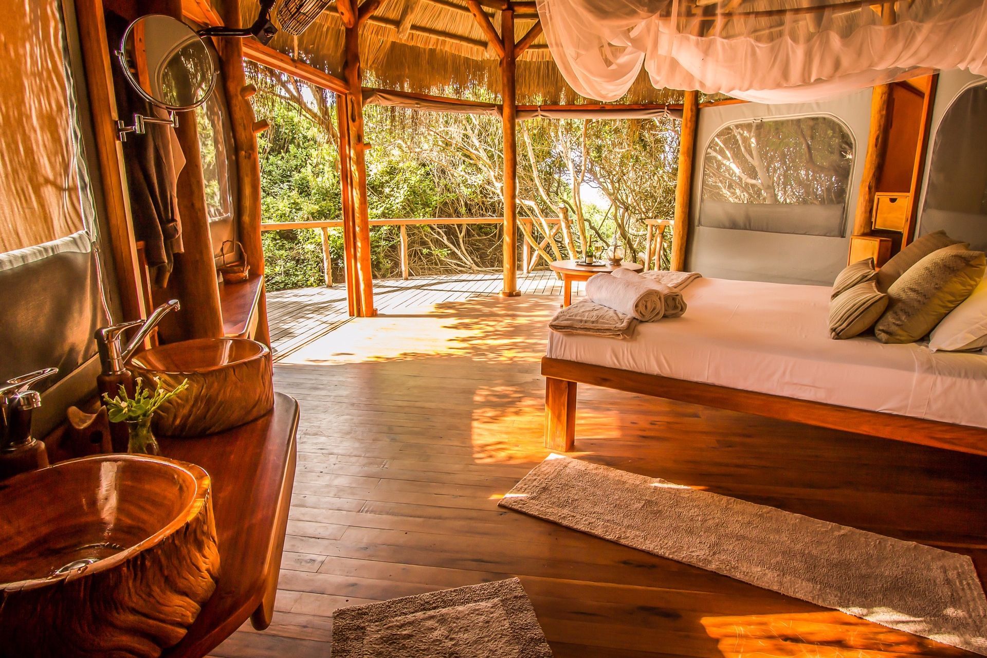 A bedroom with a canopy bed and a sink.