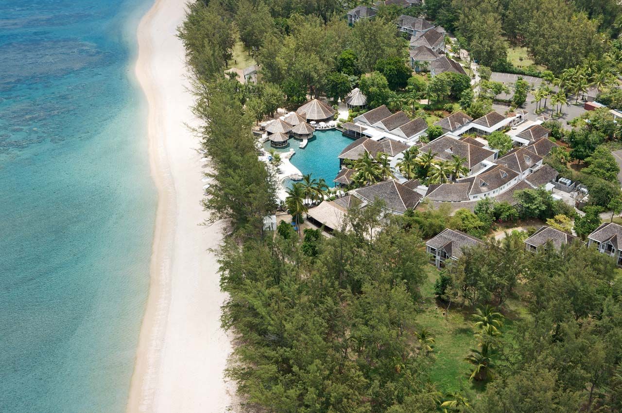 An aerial view of a beach resort with a large pool
