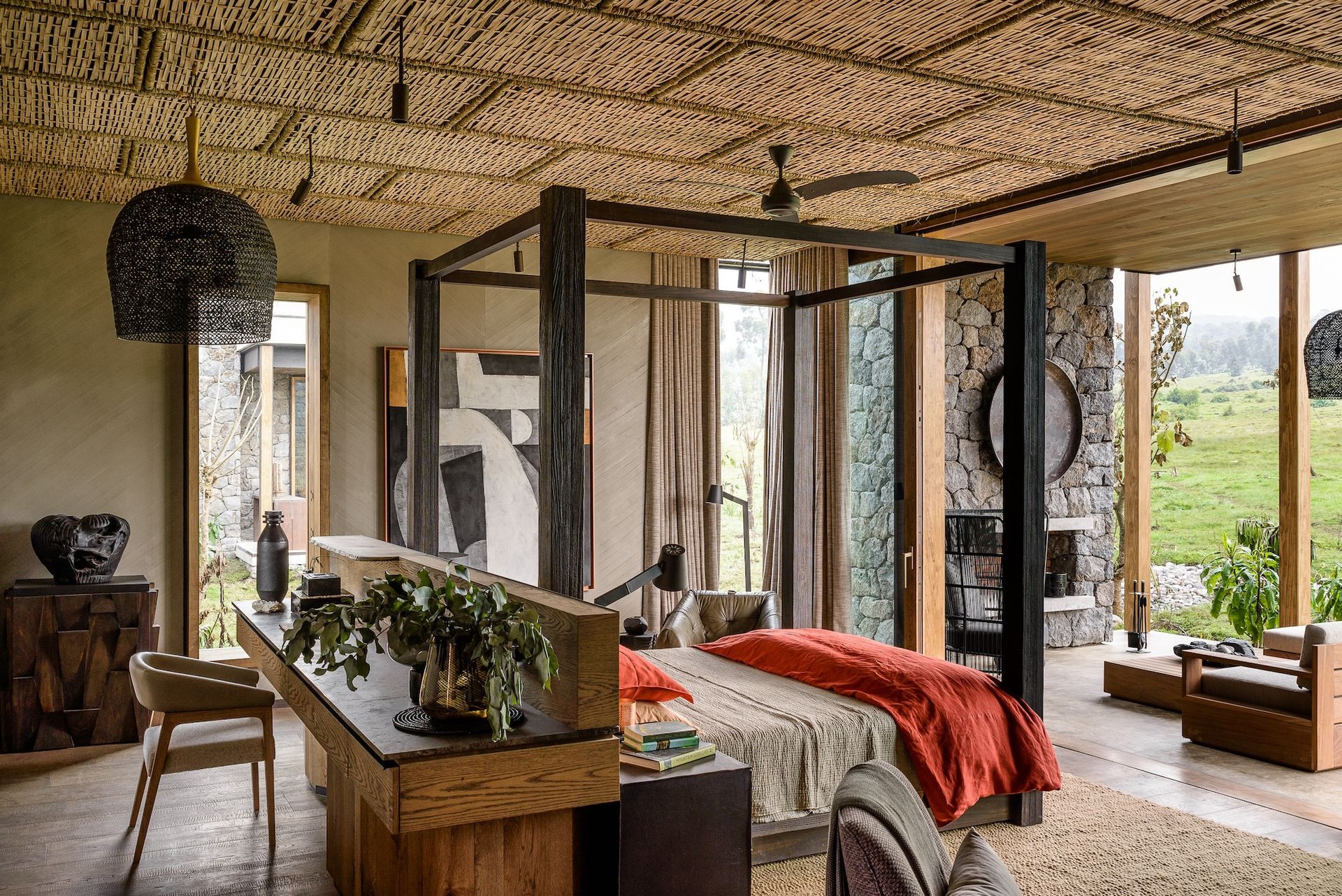 A bedroom with a canopy bed and a desk.