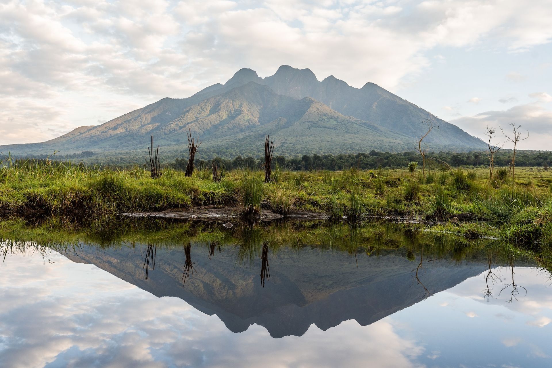 A mountain is reflected in a body of water.