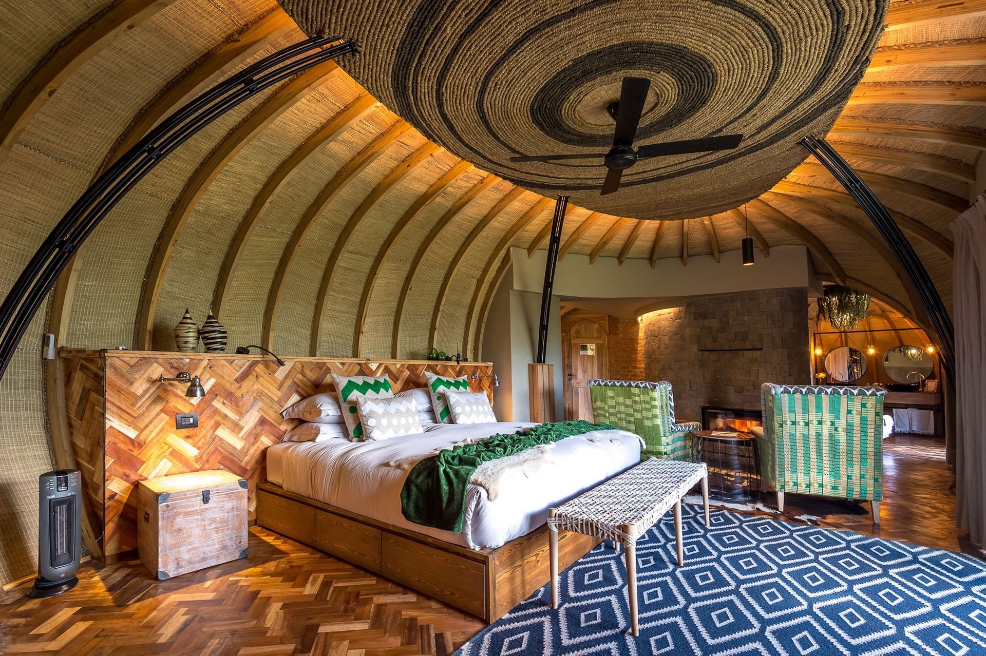 A bedroom with a large bed and a clock on the ceiling.