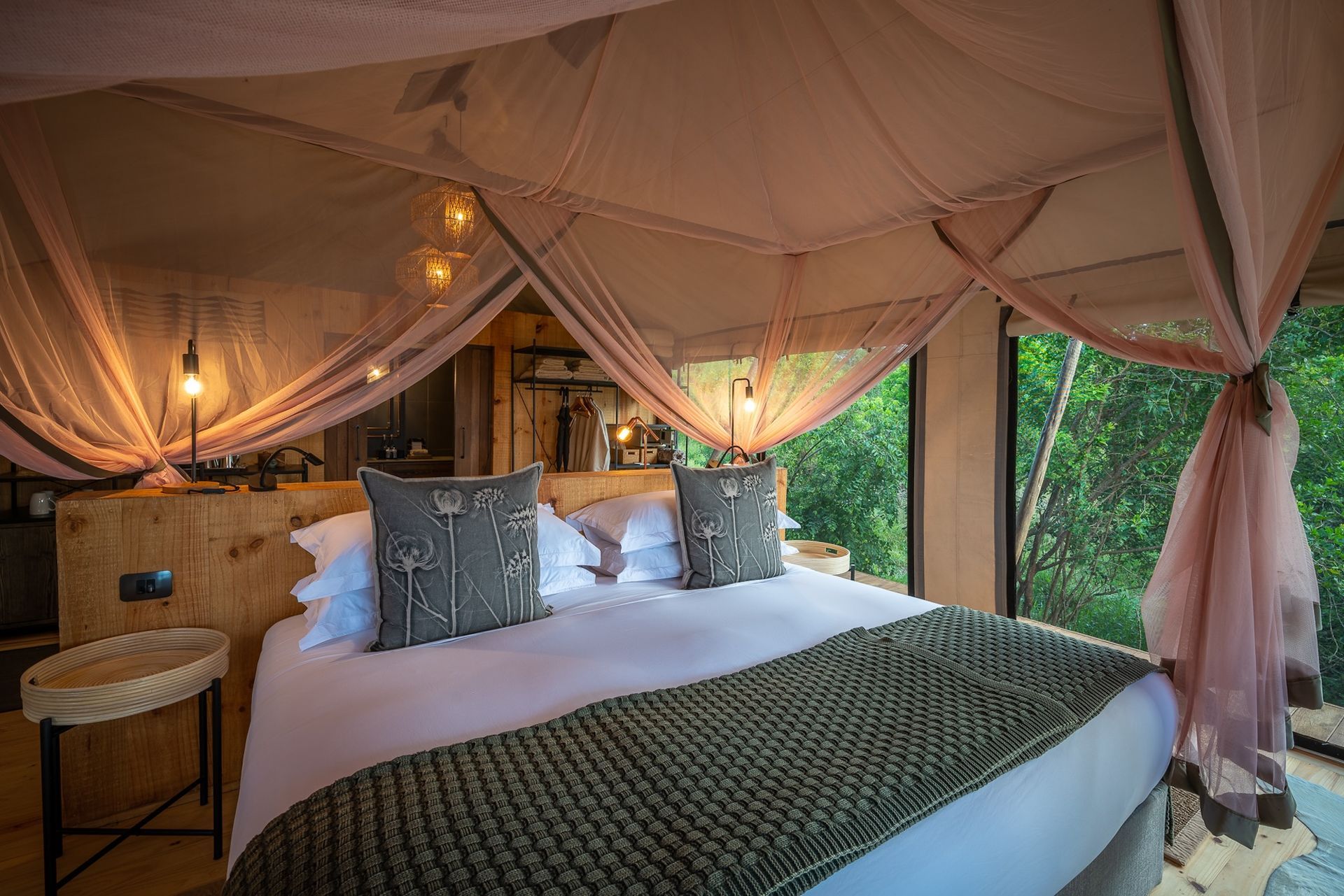 A bed in a tent with a canopy over it.