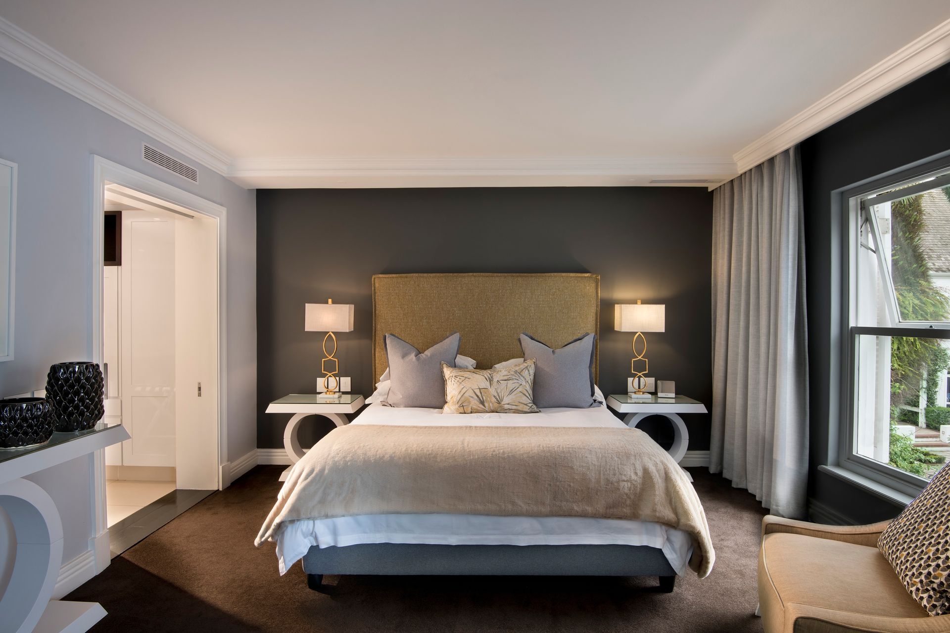 A bedroom with a large bed and two nightstands