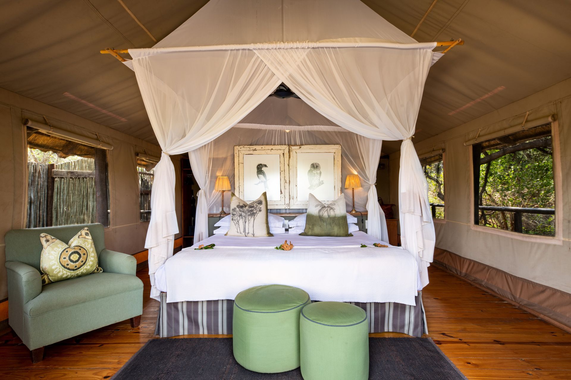 There is a canopy bed in the middle of the room.