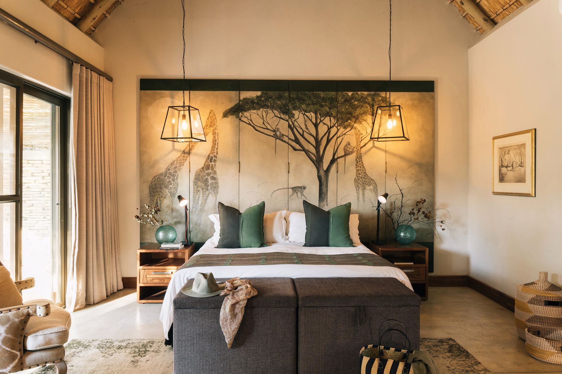 A bedroom with a king size bed and a large painting on the wall.