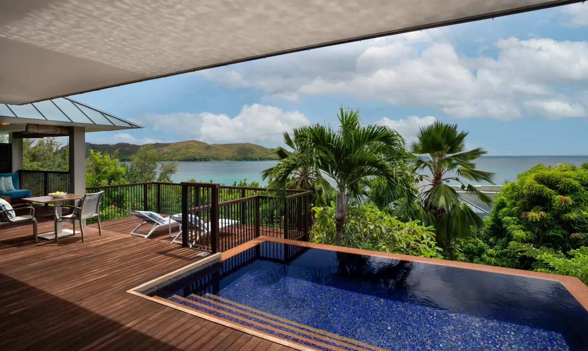 A large swimming pool on a deck overlooking the ocean