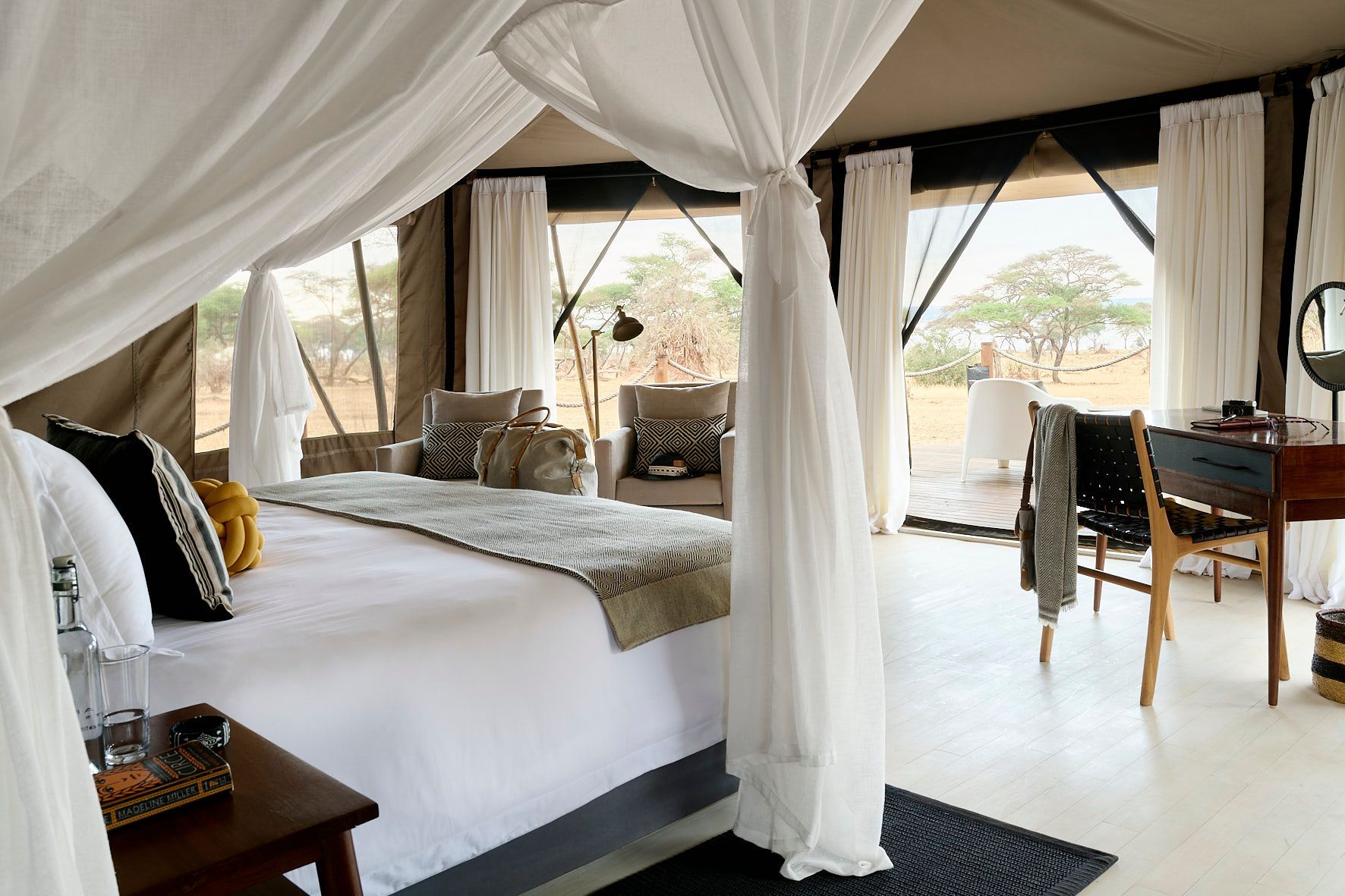 A bedroom with a canopy bed and a desk
