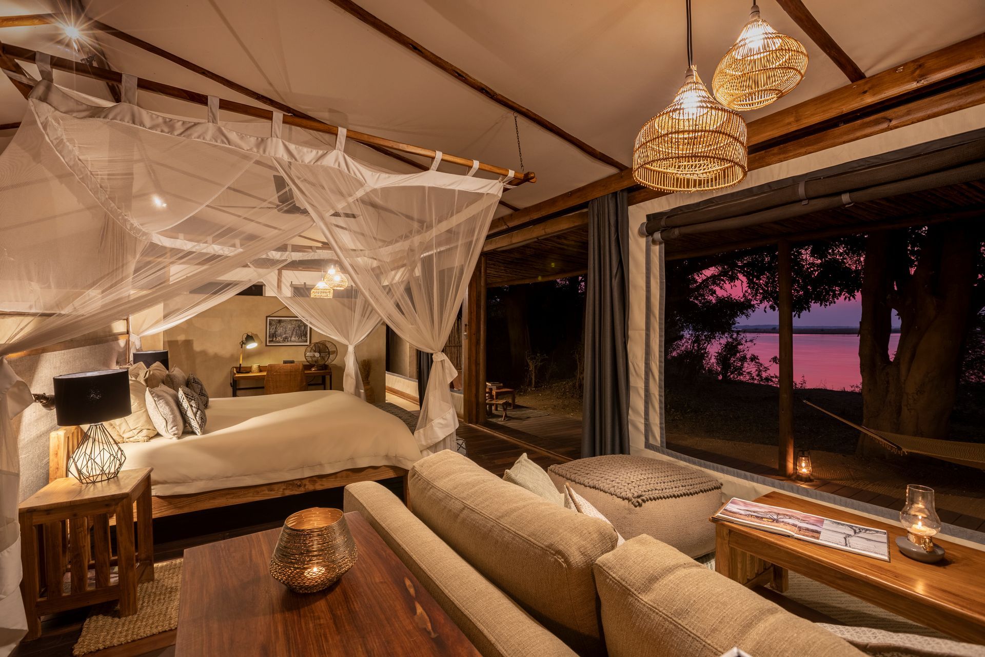 A living room with a couch and a bed with a canopy over it.