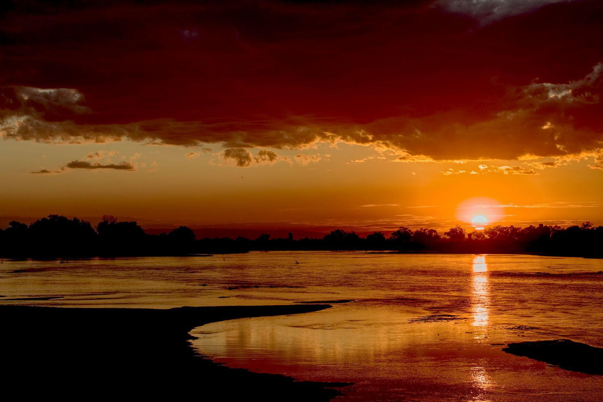 The sun is setting over a body of water.