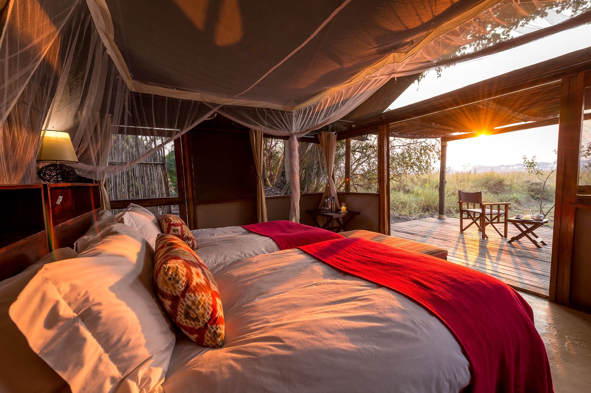 A bedroom with two beds and a canopy bed.