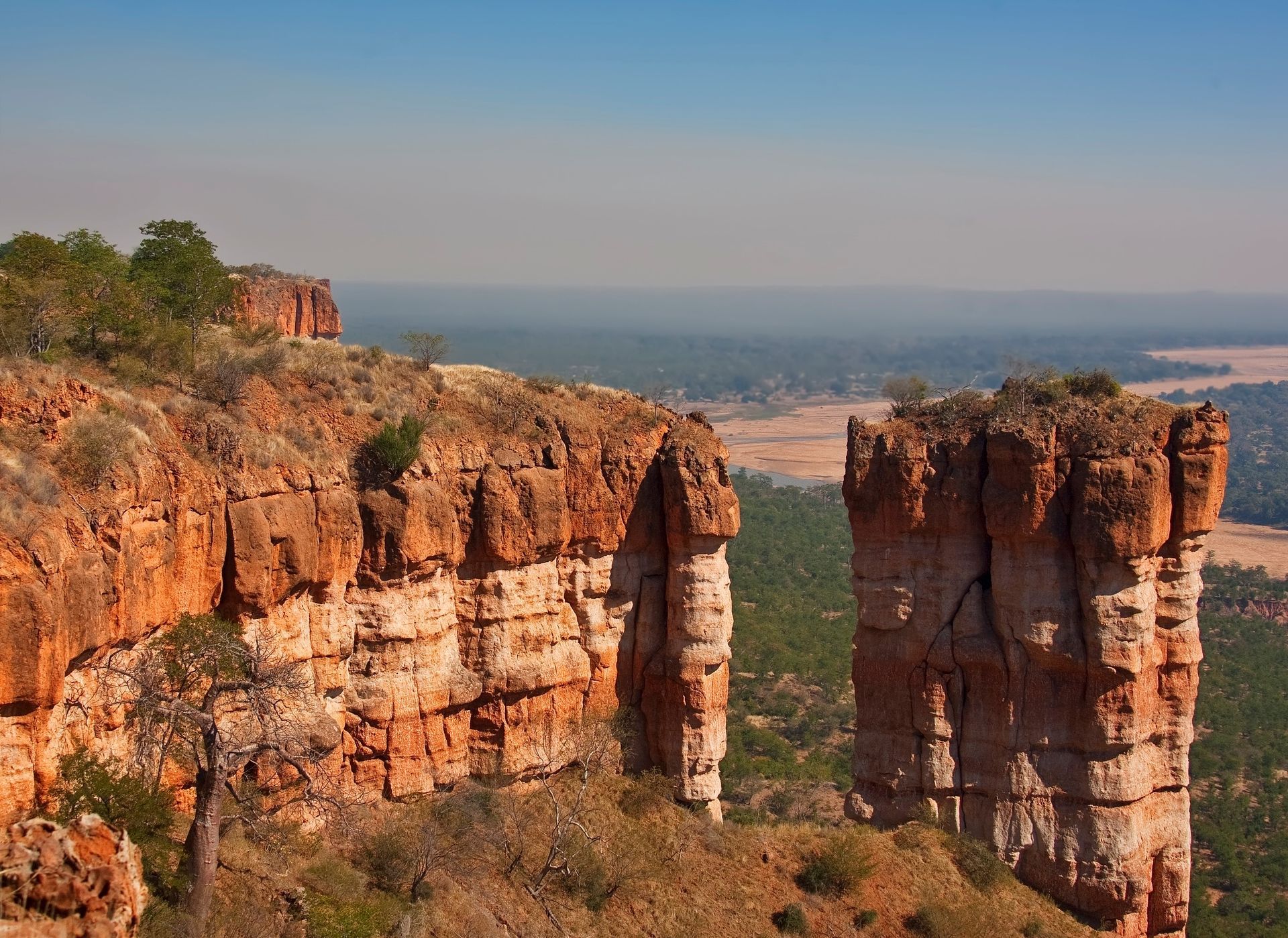 A view of a cliff with a river in the background