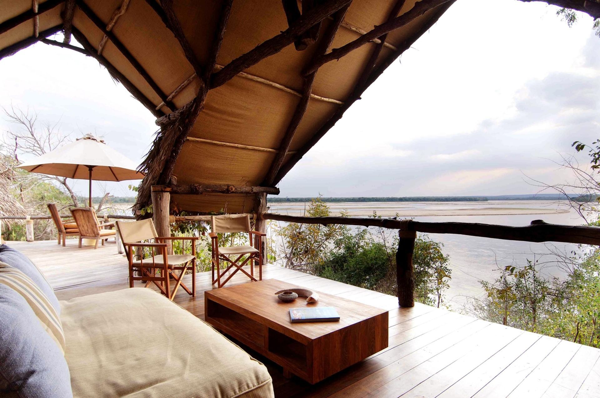 A bedroom in a tent with two beds and a canopy bed.