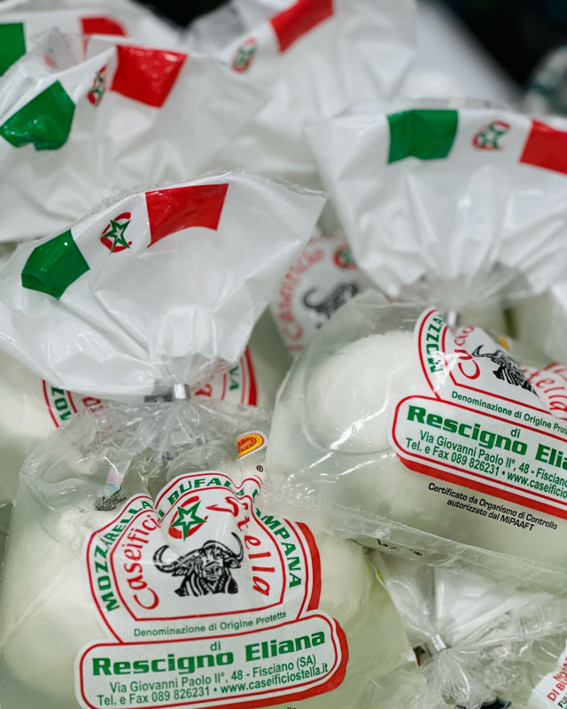 Wrapped white and green dairy candies labeled “Rescigno Eliana” in clear packaging