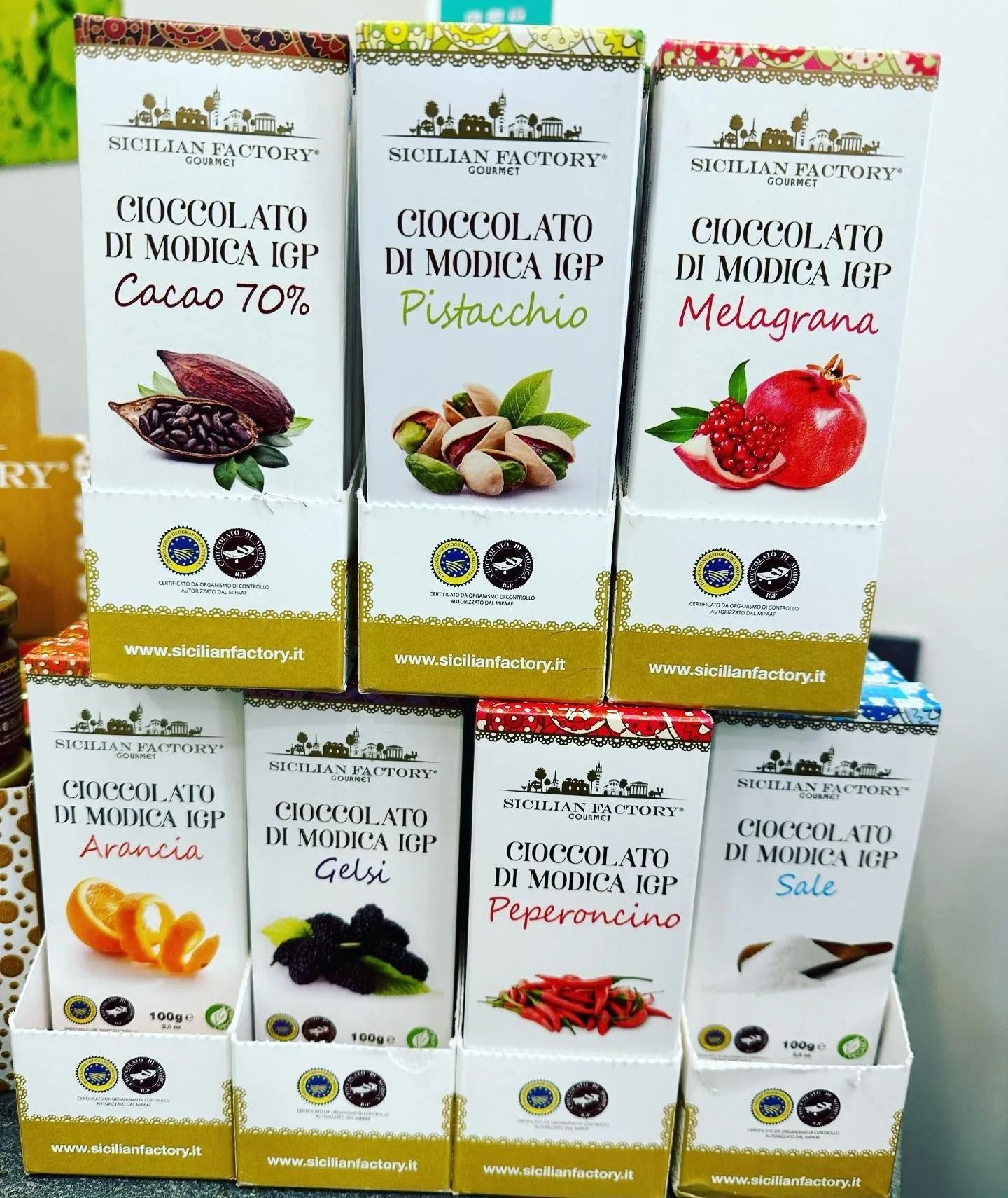 Shelf of boxed Italian gourmet food products with assorted fruit flavors and jars on display