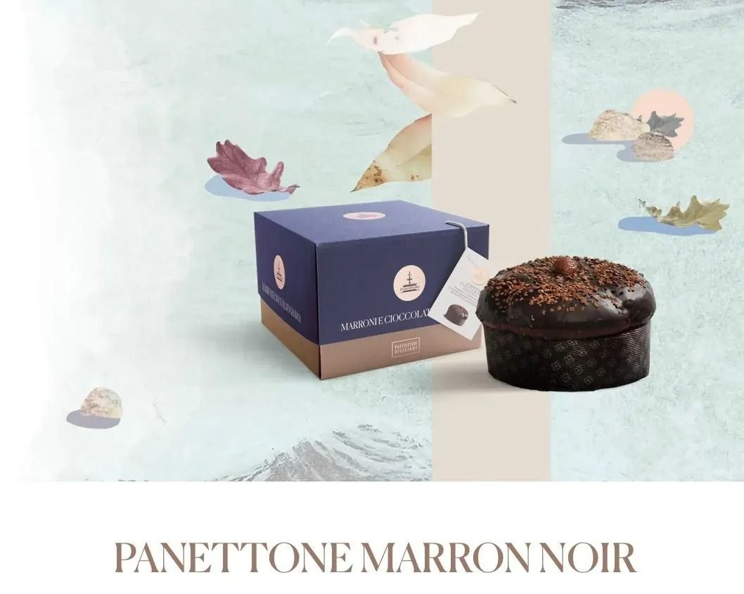 Panettone Marron Noir box beside a dark chocolate cake with soft floral graphics on a pale background
