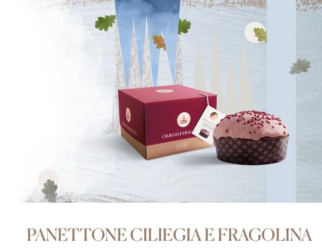 Panettone ciliegia e fragolina with maroon box and pink-topped cake on a pale winter background