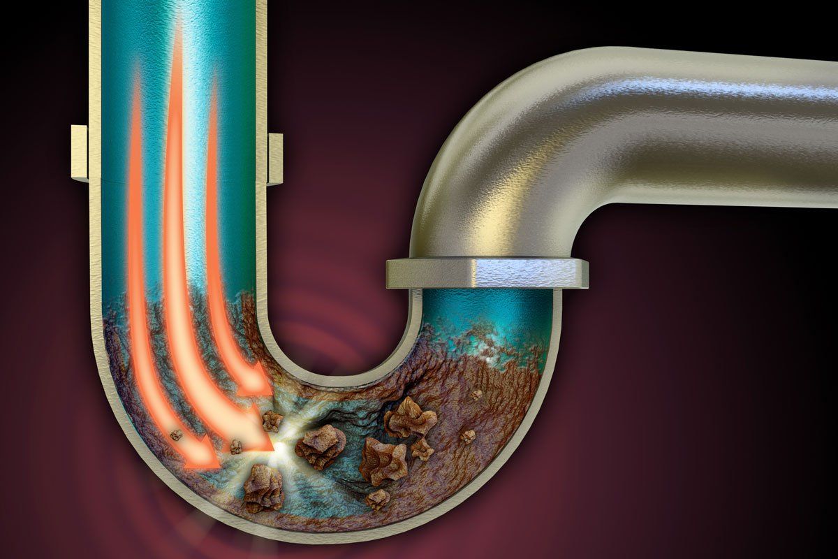 A drain pipe with a lot of dirt and rocks coming out of it.