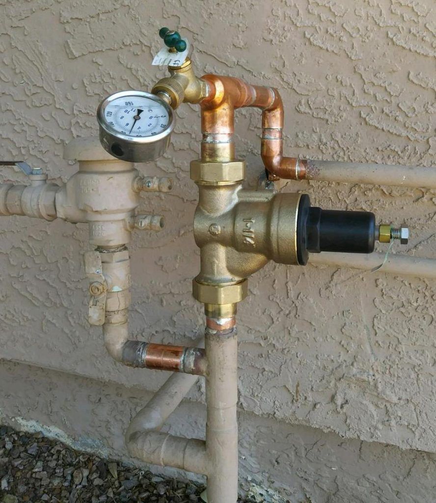 A copper pipe with a pressure gauge attached to it