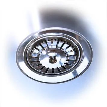 A close up of a stainless steel sink drain on a white background.
