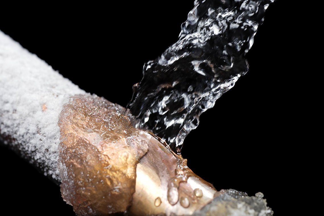 A close up of a pipe with water coming out of it.