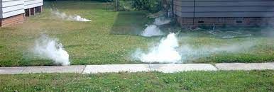 There is sewer smoke test coming out of the sewer trouble spots