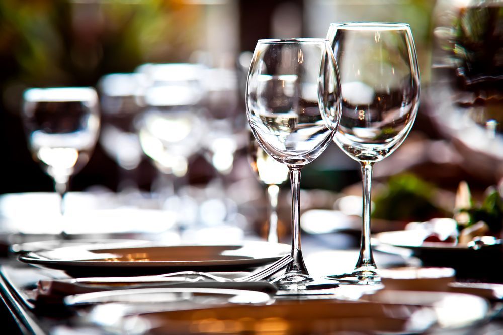 A row of wine glasses sitting on top of a table.