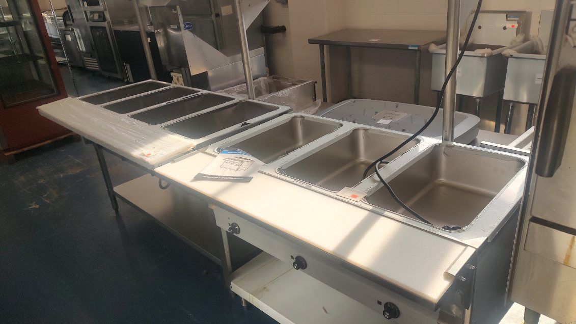 A stainless steel sink is sitting on top of a counter in a kitchen.