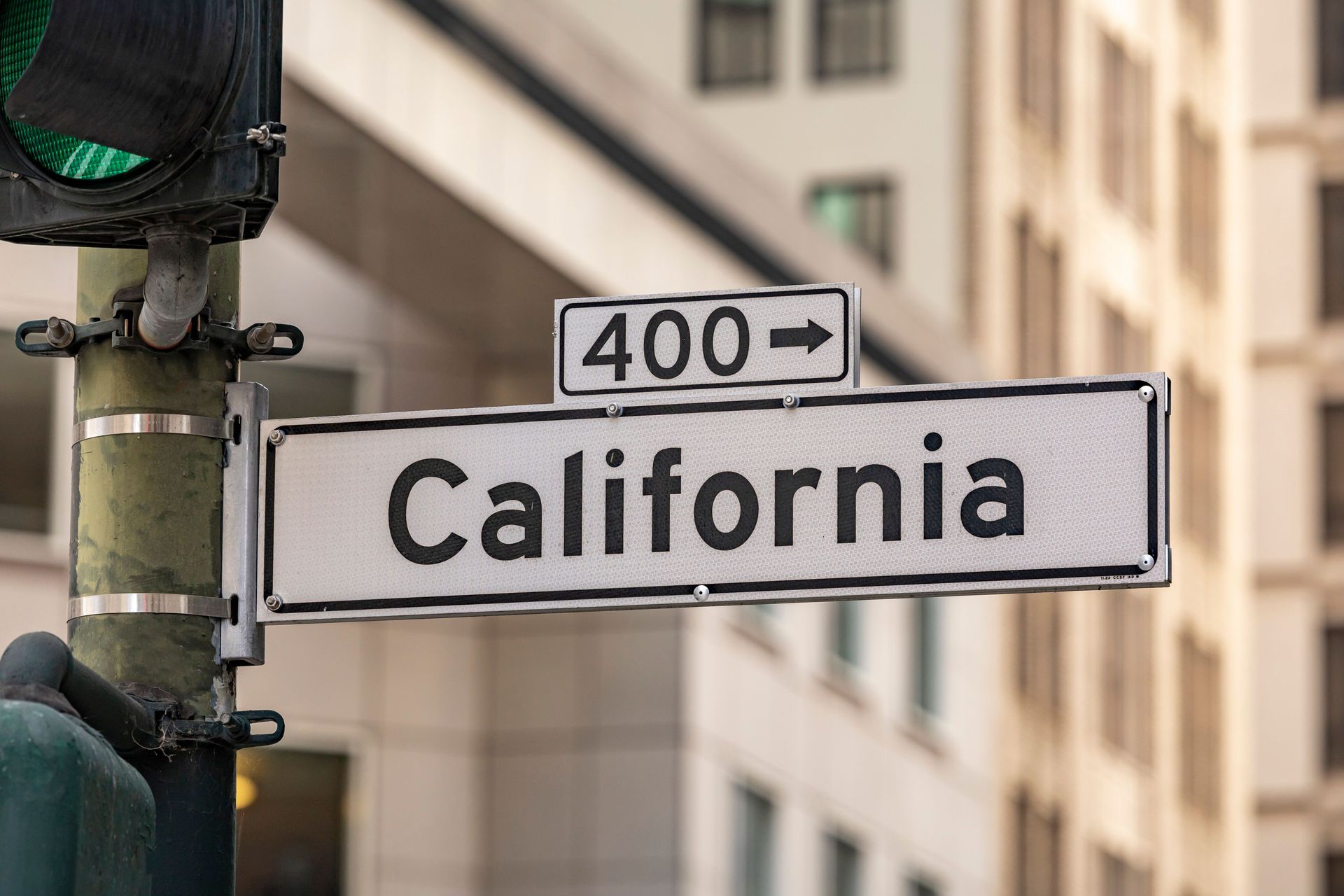 Street sign reading California with 400 and a right arrow on a city corner