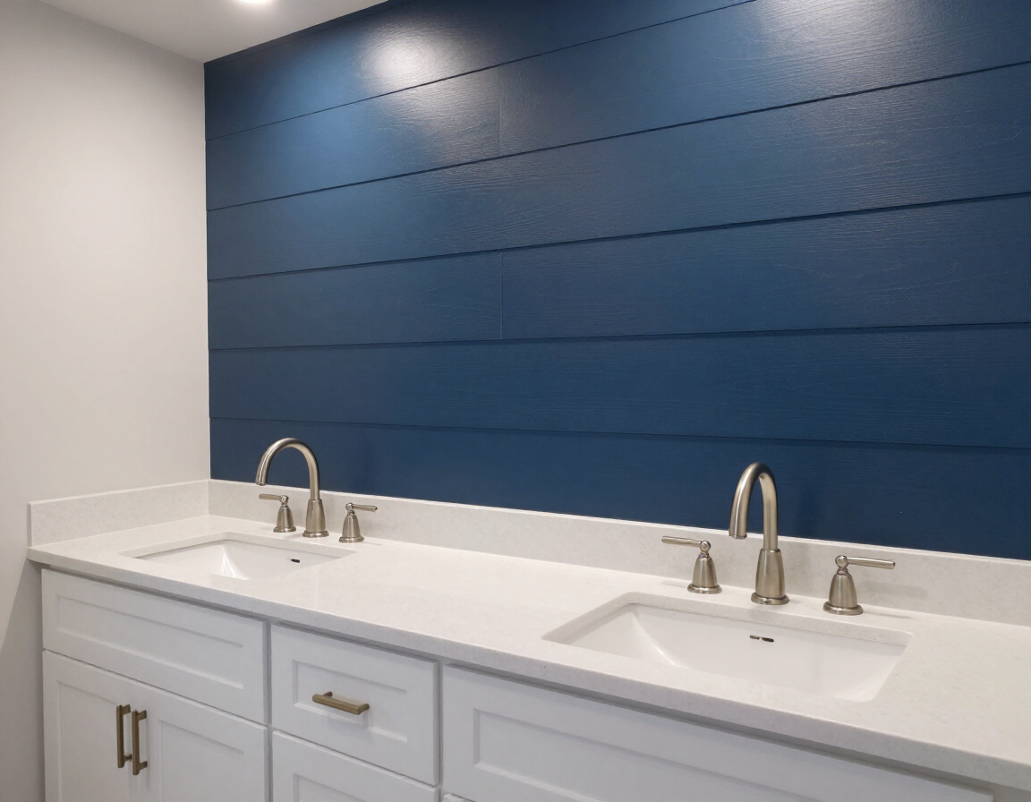 Double vanity with quartz countertop and brushed nickel faucets against navy shiplap