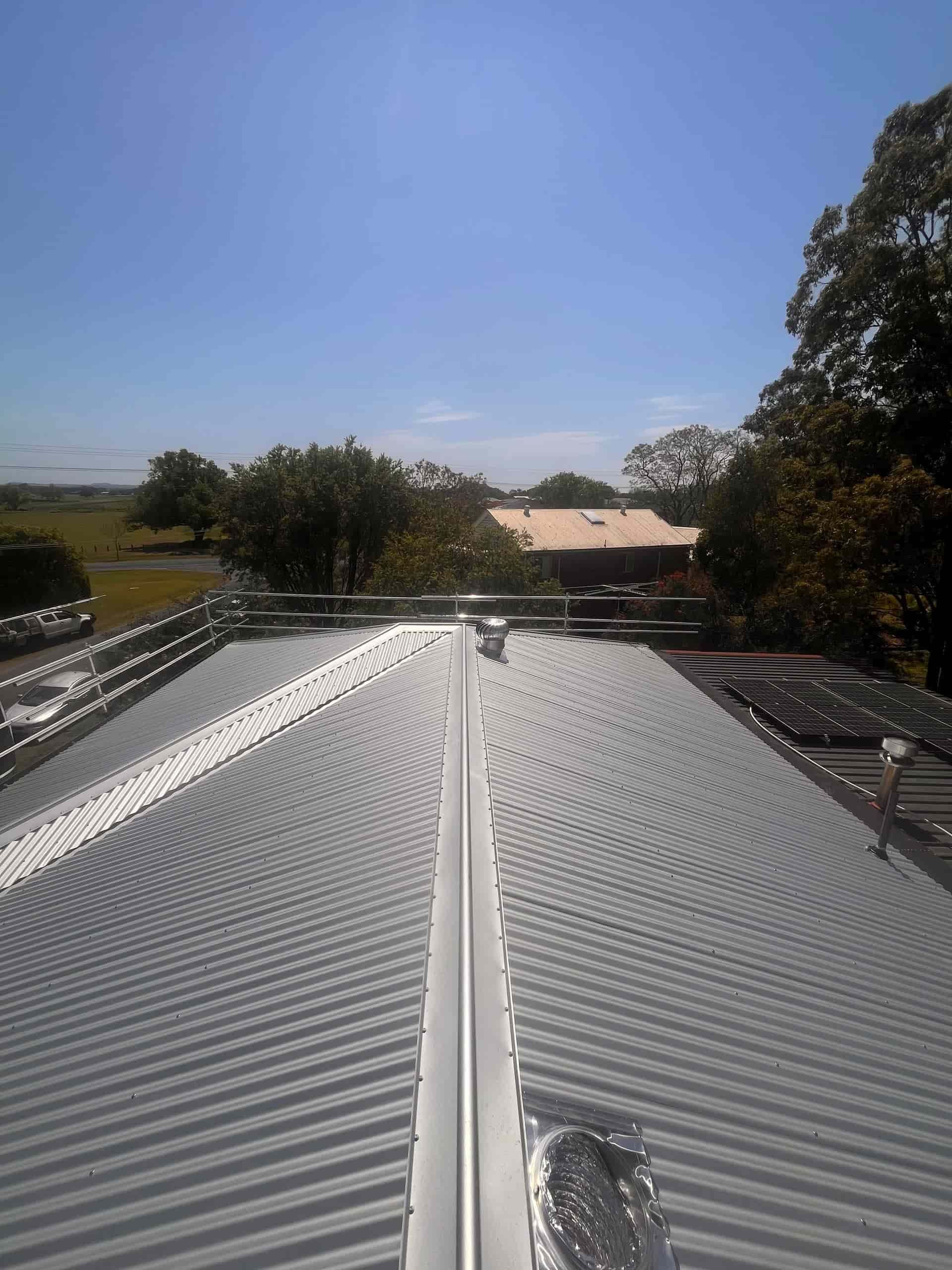 A Metal Roof With a Triangle on Top of It — Eli Mcauley Constructions in Nambucca Heads, NSW