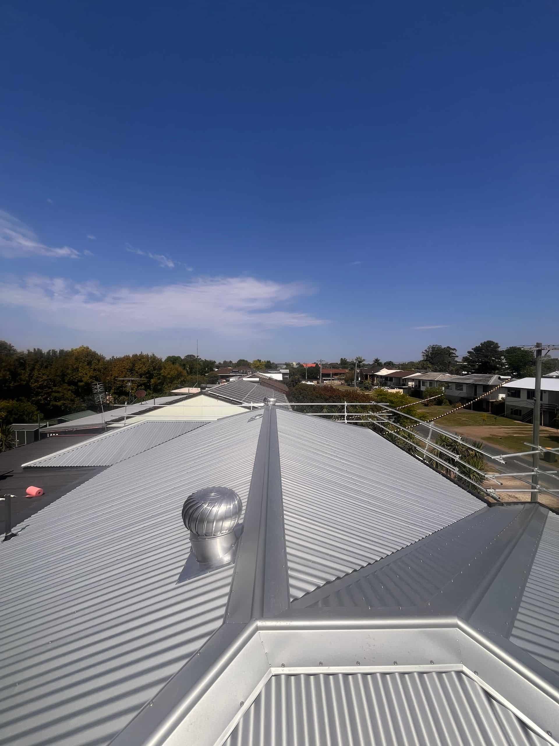 A Scaffolding is Sitting on Top of a Brick Building — Eli Mcauley Constructions in Nambucca Heads, NSW