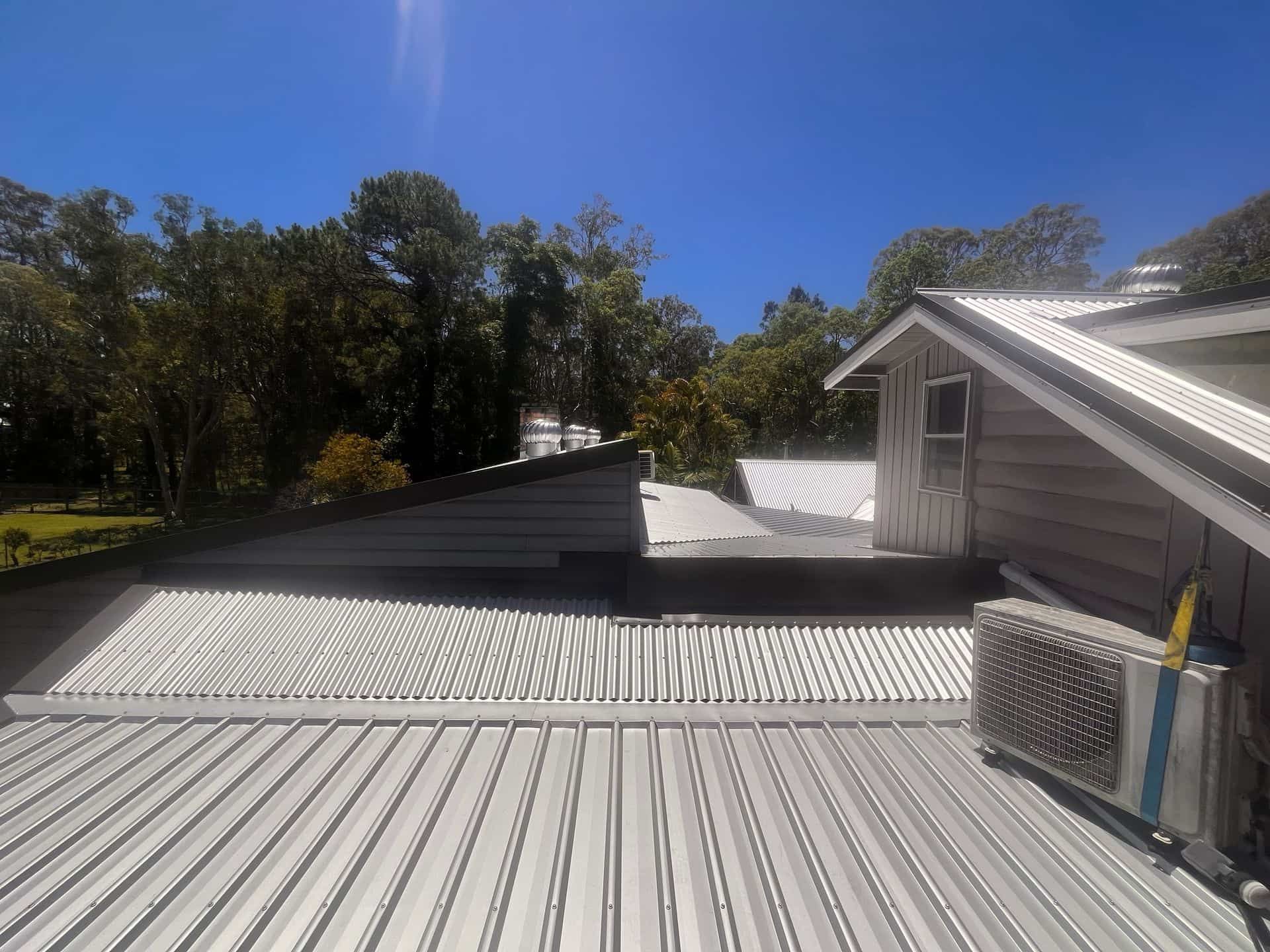 A Building is Being Built With Scaffolding and a Large Window — Eli Mcauley Constructions in Coffs Harbour, NSW