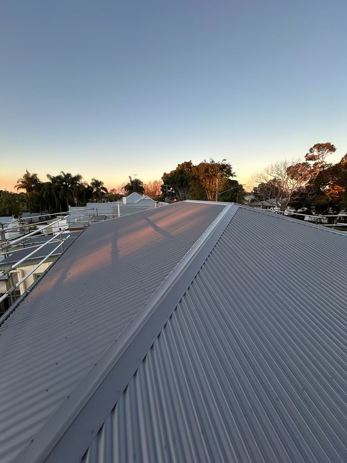 A Close Up of a Metal Roof With a Blue Sky in the Background — Eli Mcauley Constructions in Grafton, NSW