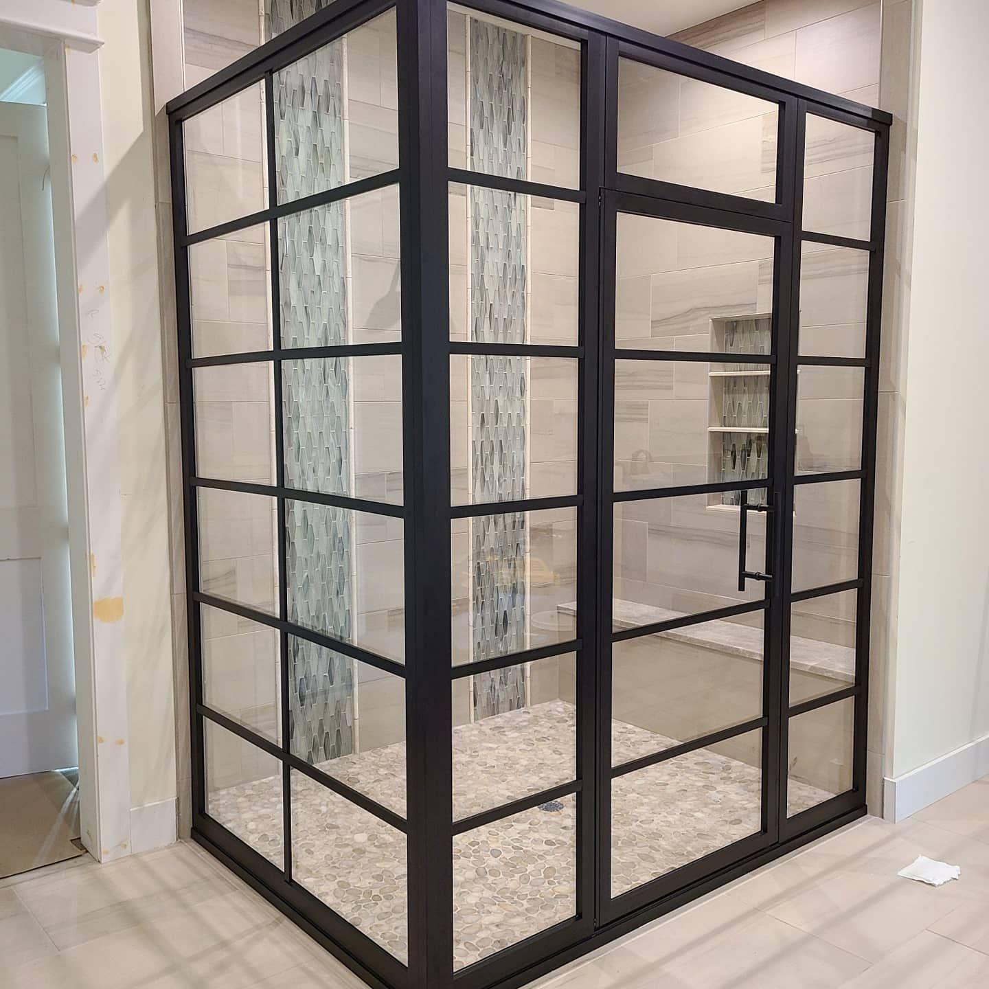 A room with a lot of glass doors and a black frame.