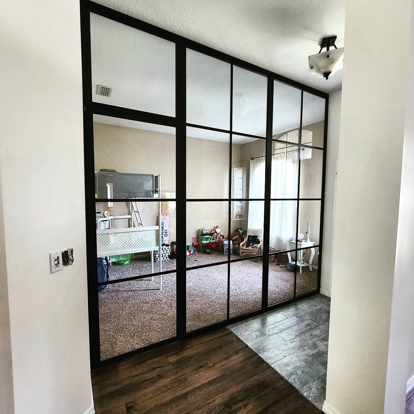 A room with a lot of windows and a sliding glass door.