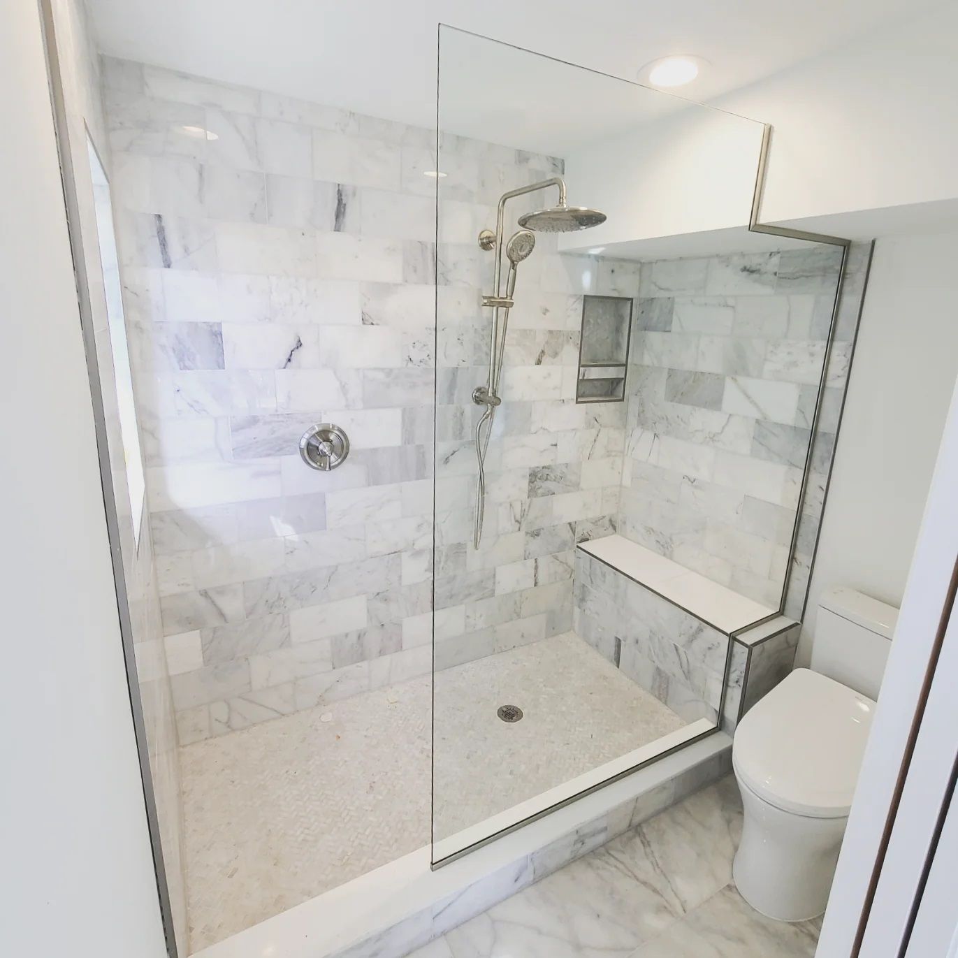 A bathroom with a walk in shower and a toilet