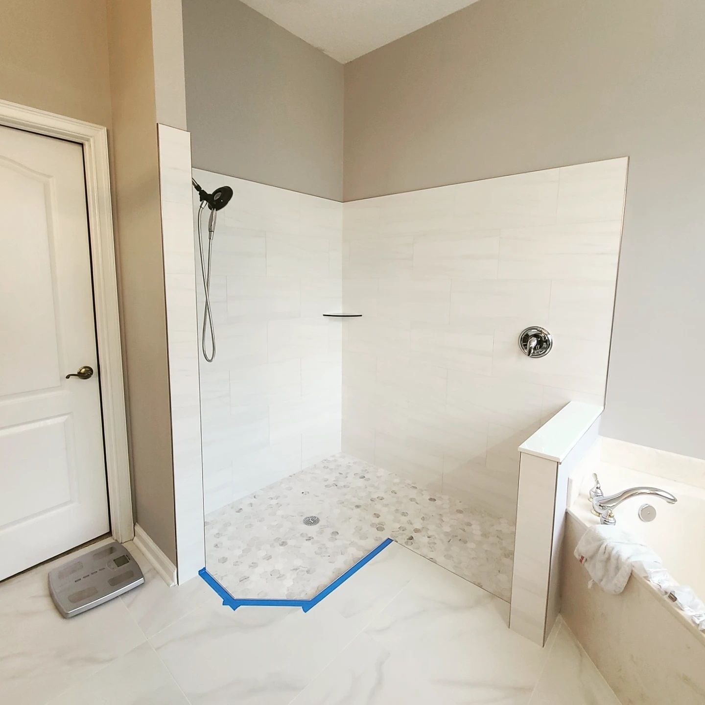 A bathroom with a walk in shower and a bathtub