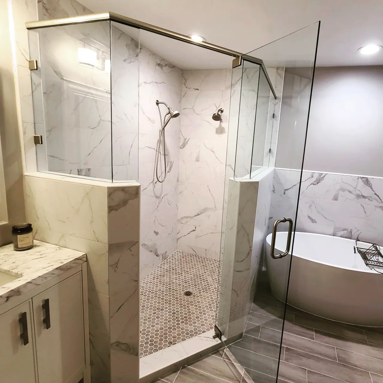 A bathroom with a walk in shower and a bathtub