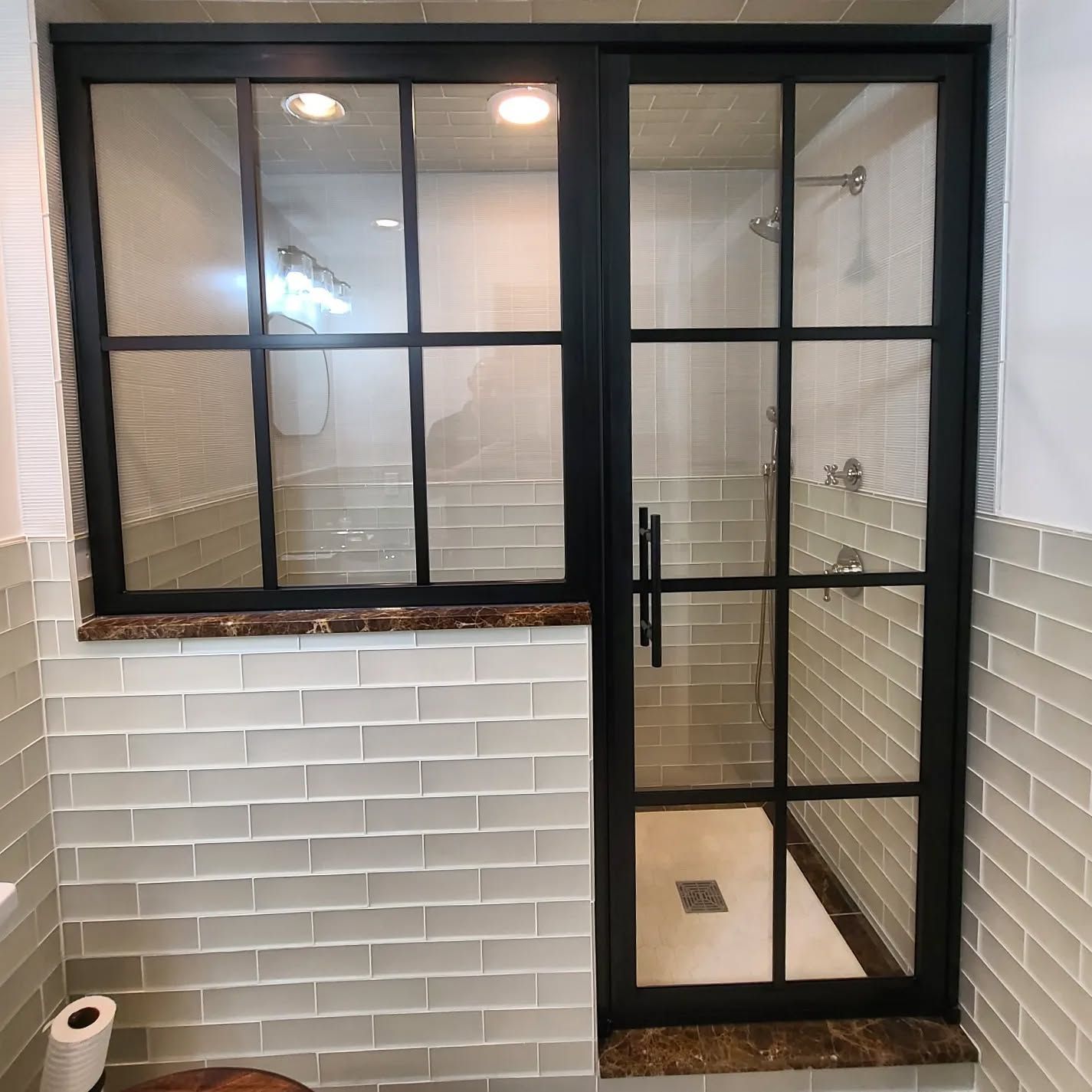 A bathroom with a toilet and a glass shower door